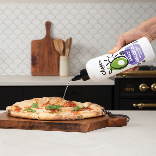 Garlic Infused Avocado Oil Bottle pouring oil on a pizza